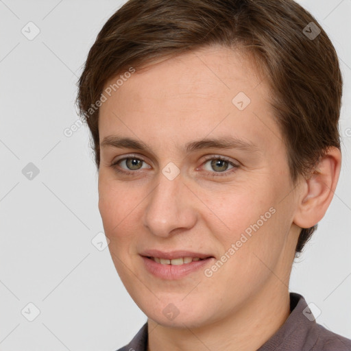 Joyful white young-adult female with short  brown hair and grey eyes