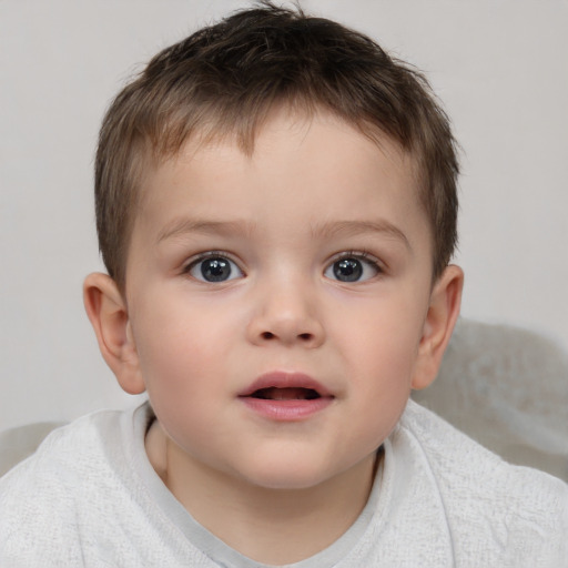 Joyful white child male with short  brown hair and brown eyes