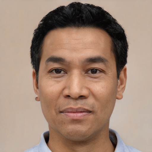 Joyful asian adult male with short  black hair and brown eyes