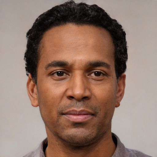 Neutral latino adult male with short  black hair and brown eyes