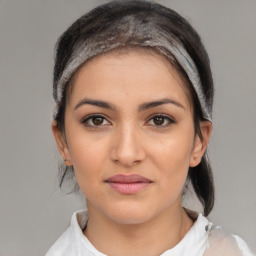 Joyful latino young-adult female with medium  brown hair and brown eyes