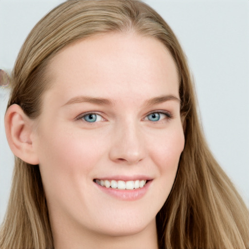 Joyful white young-adult female with long  brown hair and blue eyes