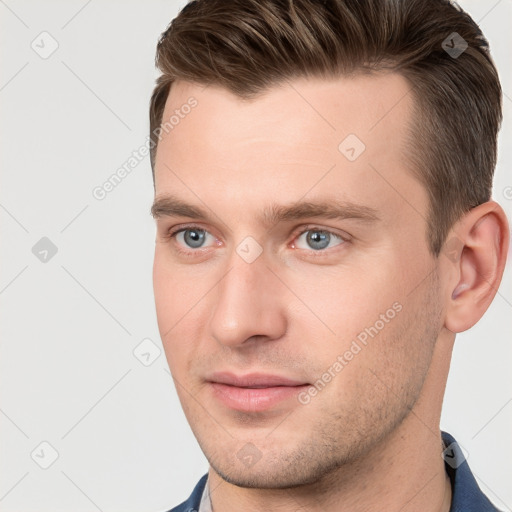 Joyful white young-adult male with short  brown hair and grey eyes