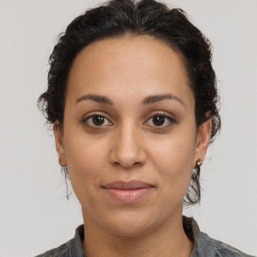 Joyful latino young-adult female with medium  brown hair and brown eyes