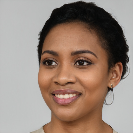 Joyful latino young-adult female with short  black hair and brown eyes