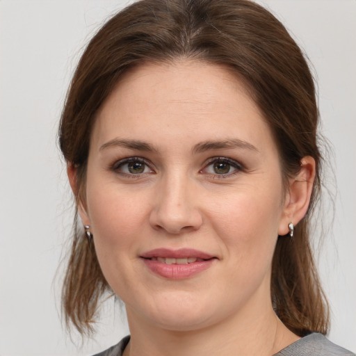 Joyful white young-adult female with medium  brown hair and grey eyes