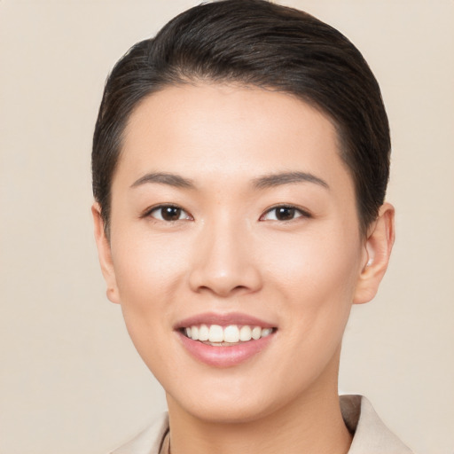 Joyful asian young-adult female with short  brown hair and brown eyes