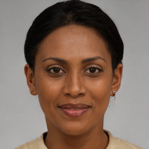 Joyful latino adult female with short  black hair and brown eyes