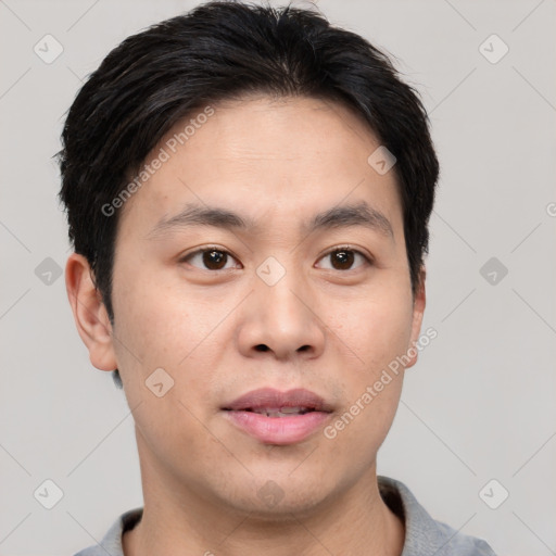 Joyful asian young-adult male with short  brown hair and brown eyes