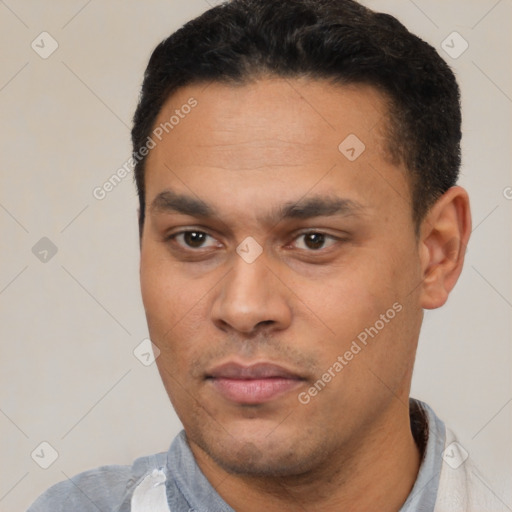 Joyful latino young-adult male with short  black hair and brown eyes