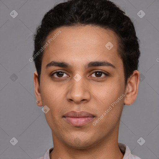 Joyful latino young-adult male with short  brown hair and brown eyes