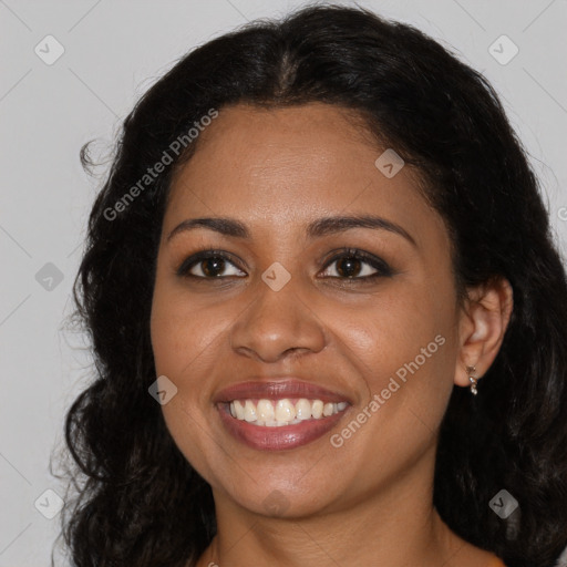 Joyful black young-adult female with long  brown hair and brown eyes