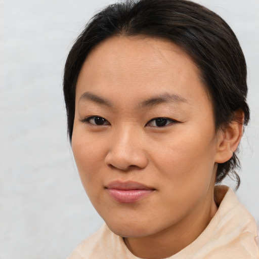 Joyful asian young-adult female with short  brown hair and brown eyes