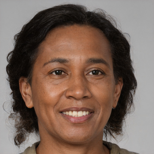 Joyful black adult female with medium  brown hair and brown eyes