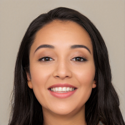 Joyful white young-adult female with long  black hair and brown eyes