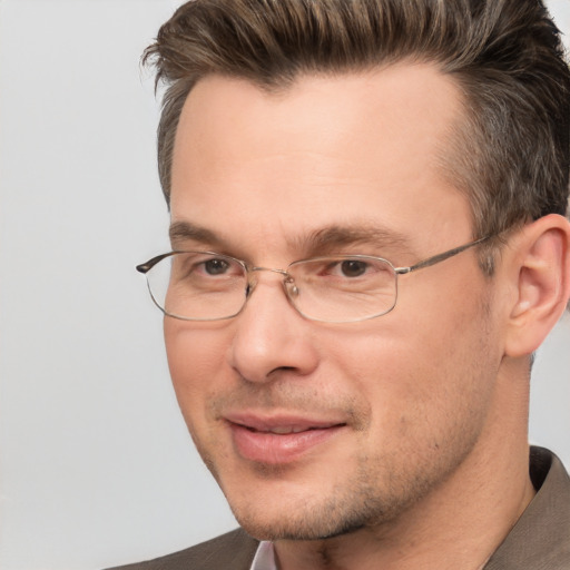 Joyful white adult male with short  brown hair and brown eyes