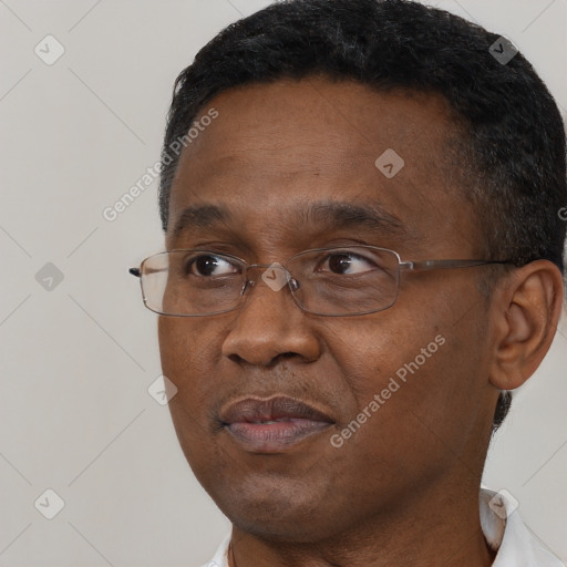 Joyful black adult male with short  brown hair and brown eyes