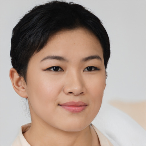 Joyful asian young-adult female with short  brown hair and brown eyes