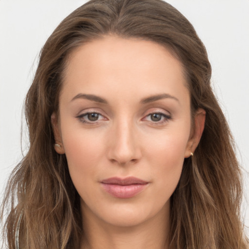 Joyful white young-adult female with long  brown hair and grey eyes