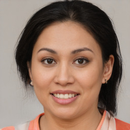 Joyful latino young-adult female with medium  brown hair and brown eyes