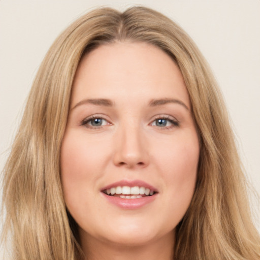 Joyful white young-adult female with long  brown hair and brown eyes