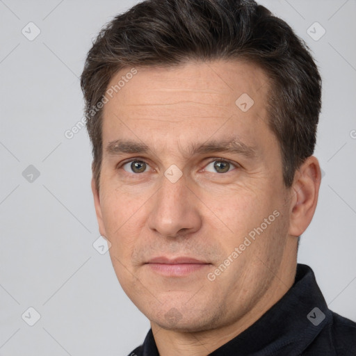 Joyful white adult male with short  brown hair and brown eyes