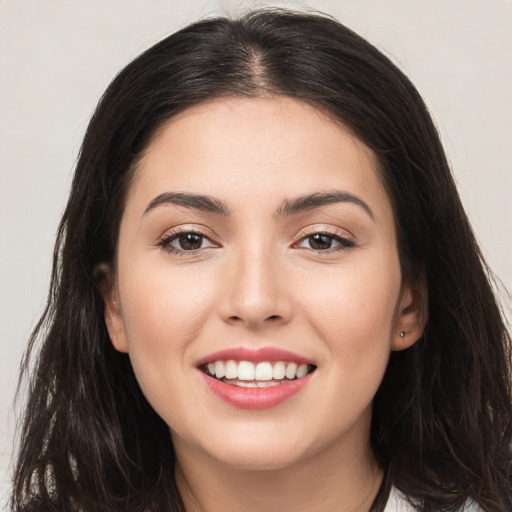 Joyful white young-adult female with long  brown hair and brown eyes