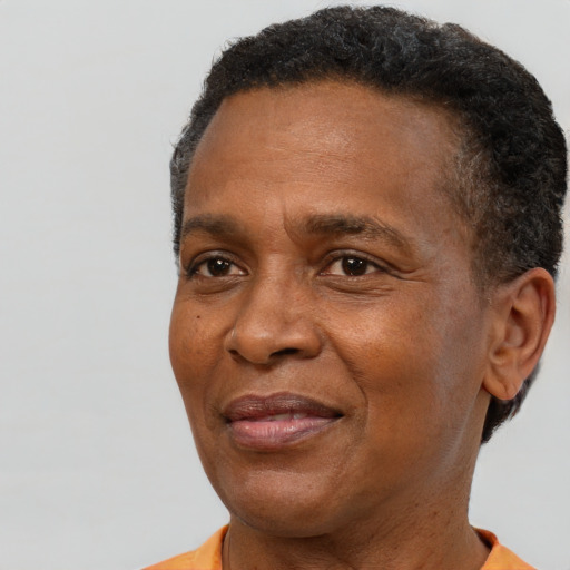 Joyful black adult male with short  brown hair and brown eyes
