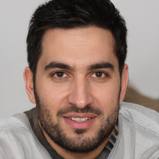 Joyful white young-adult male with short  black hair and brown eyes