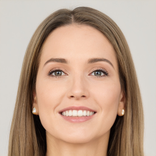 Joyful white young-adult female with long  brown hair and green eyes