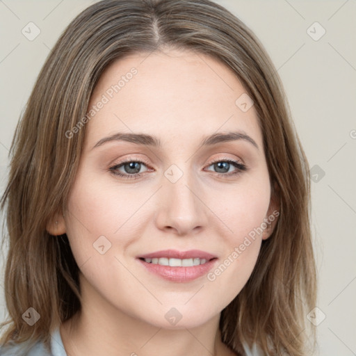 Joyful white young-adult female with long  brown hair and blue eyes