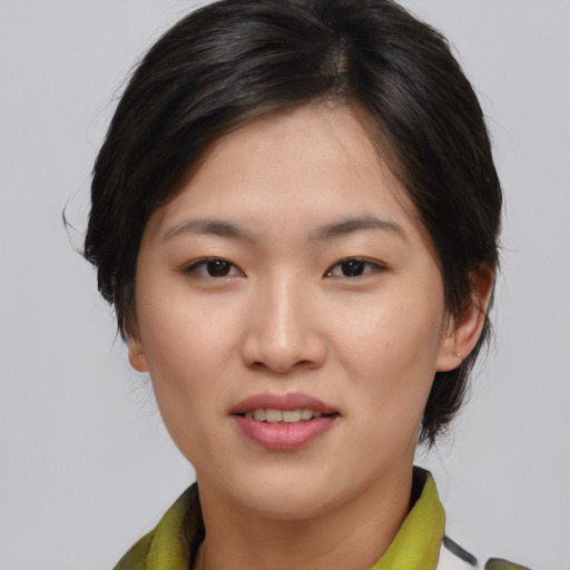 Joyful asian young-adult female with medium  brown hair and brown eyes