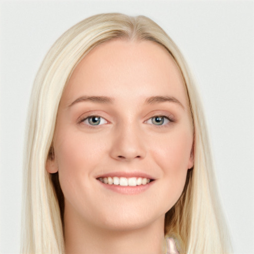 Joyful white young-adult female with long  brown hair and blue eyes