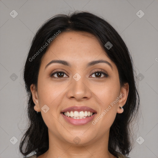 Joyful latino young-adult female with medium  brown hair and brown eyes