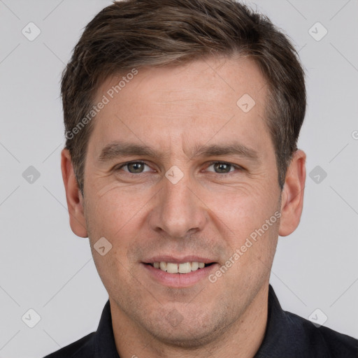 Joyful white adult male with short  brown hair and grey eyes