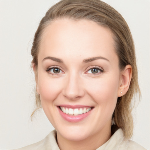 Joyful white young-adult female with medium  brown hair and blue eyes