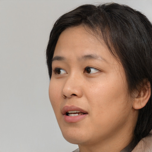 Neutral asian young-adult female with short  brown hair and brown eyes