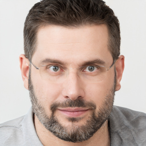 Joyful white adult male with short  brown hair and brown eyes