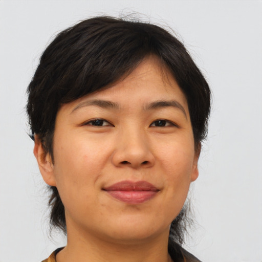Joyful asian young-adult female with medium  brown hair and brown eyes