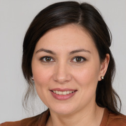 Joyful white young-adult female with medium  brown hair and brown eyes