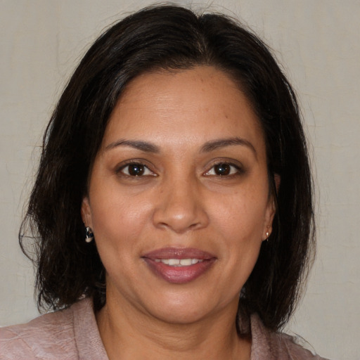 Joyful white adult female with medium  brown hair and brown eyes