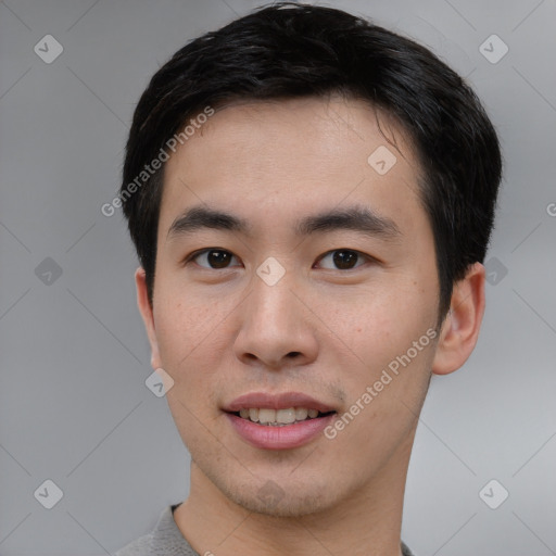 Joyful asian young-adult male with short  black hair and brown eyes