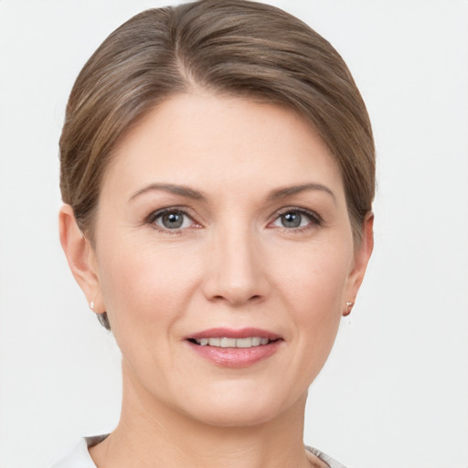 Joyful white young-adult female with short  brown hair and grey eyes