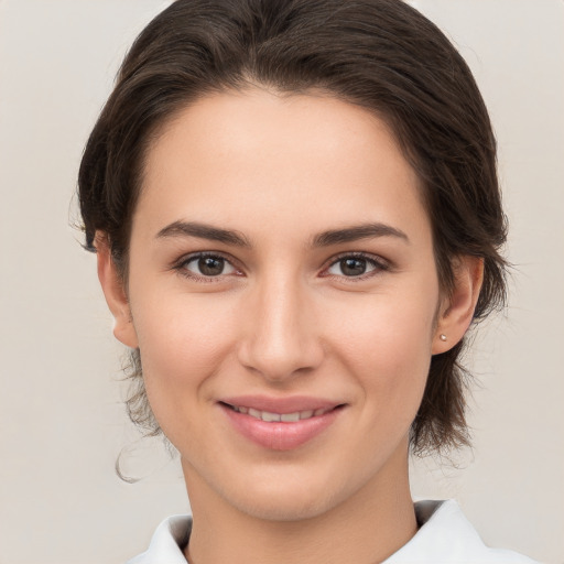 Joyful white young-adult female with medium  brown hair and brown eyes