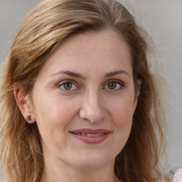 Joyful white adult female with long  brown hair and brown eyes