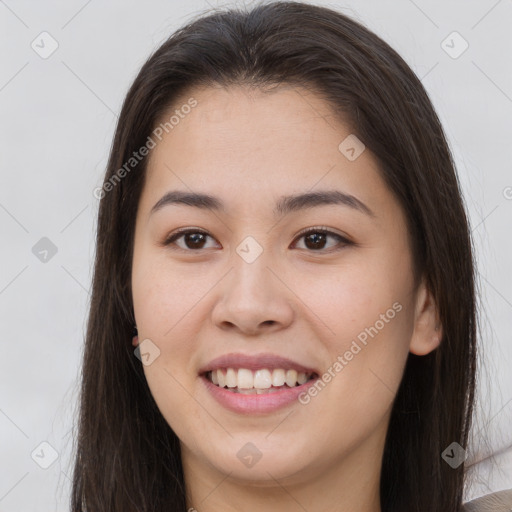 Joyful white young-adult female with long  brown hair and brown eyes