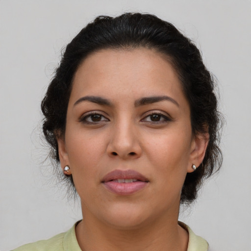 Joyful latino young-adult female with short  brown hair and brown eyes
