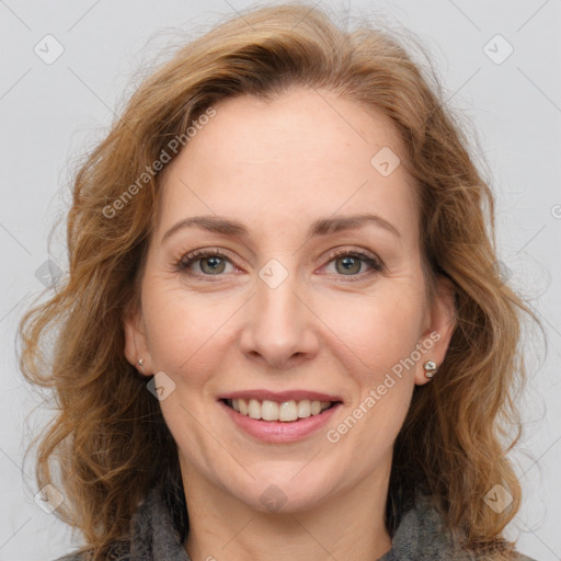 Joyful white adult female with medium  brown hair and green eyes