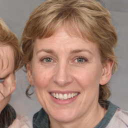 Joyful white adult female with medium  brown hair and blue eyes