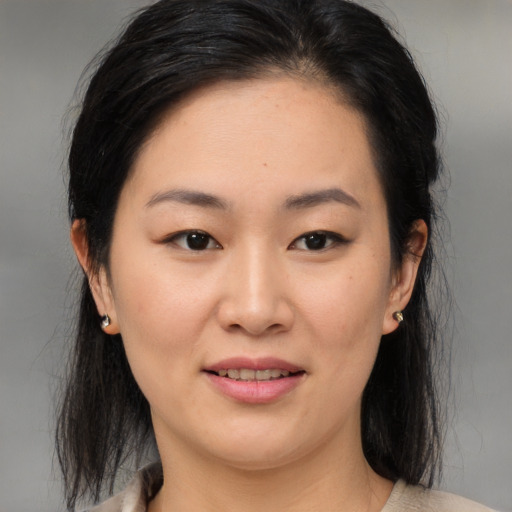 Joyful asian young-adult female with medium  brown hair and brown eyes